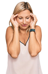 Middle age caucasian woman wearing casual clothes with hand on head, headache because stress. suffering migraine.