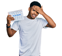 Young african american man holding rainy weather calendar stressed and frustrated with hand on head, surprised and angry face