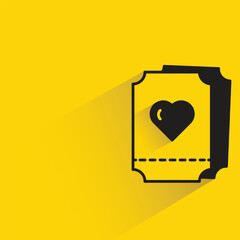 heart ticket with shadow on yellow background