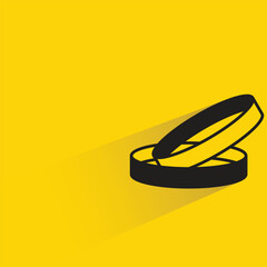 wedding ring with shadow on yellow background