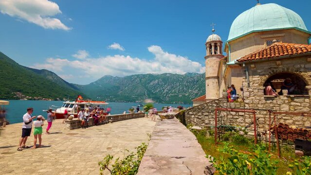 timelapse of crowds of tourists come by ships to the island of St. George, Bay of Kotor near Perast, Montenegro, and take a walk, a bright sunny day, a journey
