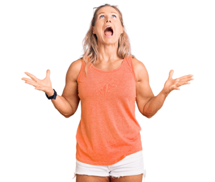 Middle age fit blonde woman wearing casual summer clothes and sunglasses crazy and mad shouting and yelling with aggressive expression and arms raised. frustration concept.