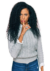 Middle age african american woman wearing casual clothes asking to be quiet with finger on lips. silence and secret concept.