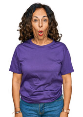 Fototapeta premium Middle age hispanic woman wearing casual clothes afraid and shocked with surprise expression, fear and excited face.