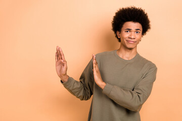 Photo of good mood nice handsome guy with afro hairstyle wear khaki shirt palms showing no gesture...