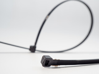 Plastic black ties on a white background. Plastic ties for cables.
