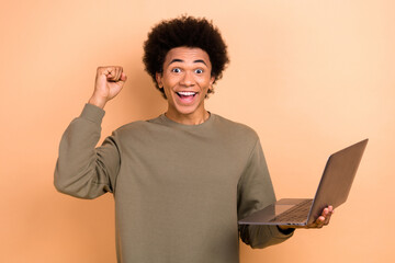 Photo of youngster excited overjoyed successful junior it programmer fist up just done his first...