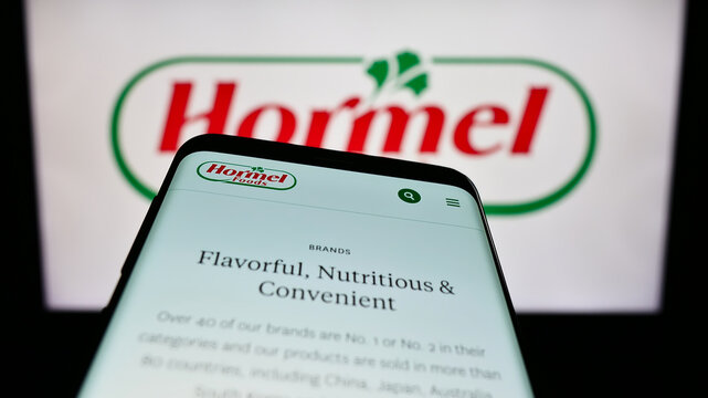 Stuttgart, Germany - 07-02-2023: Mobile phone with website of US food company Hormel Foods Corporation on screen in front of business logo. Focus on top-left of phone display.