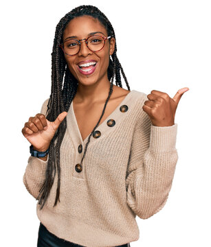 African American Woman Wearing Casual Clothes Pointing To The Back Behind With Hand And Thumbs Up, Smiling Confident