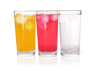 Glasses of different refreshing soda water with ice cubes on white background