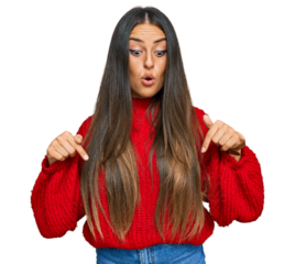 Beautiful hispanic woman wearing casual clothes pointing down with fingers showing advertisement, surprised face and open mouth