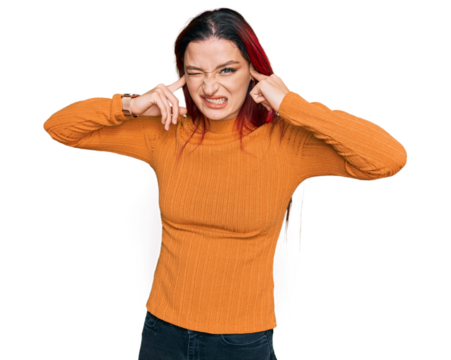 Young caucasian woman wearing casual clothes covering ears with fingers with annoyed expression for the noise of loud music. deaf concept.