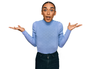 Hispanic transgender man wearing make up and long hair wearing casual clothes celebrating victory with happy smile and winner expression with raised hands