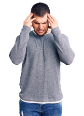 Naklejka premium Young handsome man wearing casual sweater with hand on head for pain in head because stress. suffering migraine.