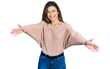 Young caucasian girl wearing casual clothes looking at the camera smiling with open arms for hug. cheerful expression embracing happiness.