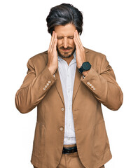 Young hispanic man wearing business clothes with hand on head, headache because stress. suffering migraine.