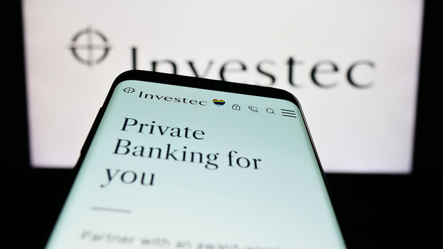 Stuttgart, Germany - 07-04-2023: Mobile phone with webpage of financial services company Investec Group on screen in front of business logo. Focus on top-left of phone display.