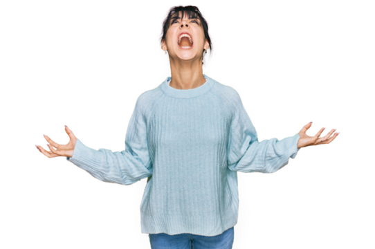 Young hispanic woman wearing casual clothes crazy and mad shouting and yelling with aggressive expression and arms raised. frustration concept.