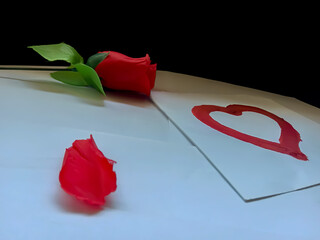 A beautiful rose and a red heart. in a black and white background . very beautiful. This is for lovers. 
