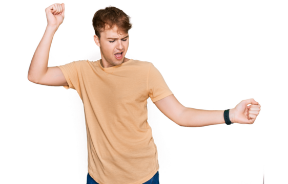 Young caucasian man wearing casual clothes dancing happy and cheerful, smiling moving casual and confident listening to music