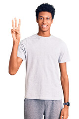 Young african american man wearing casual clothes showing and pointing up with fingers number three while smiling confident and happy.