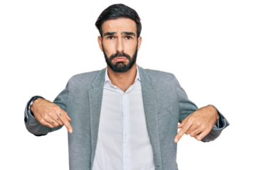 Young hispanic man wearing business clothes pointing down looking sad and upset, indicating direction with fingers, unhappy and depressed.