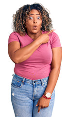 Young african american plus size woman wearing casual clothes surprised pointing with finger to the side, open mouth amazed expression.