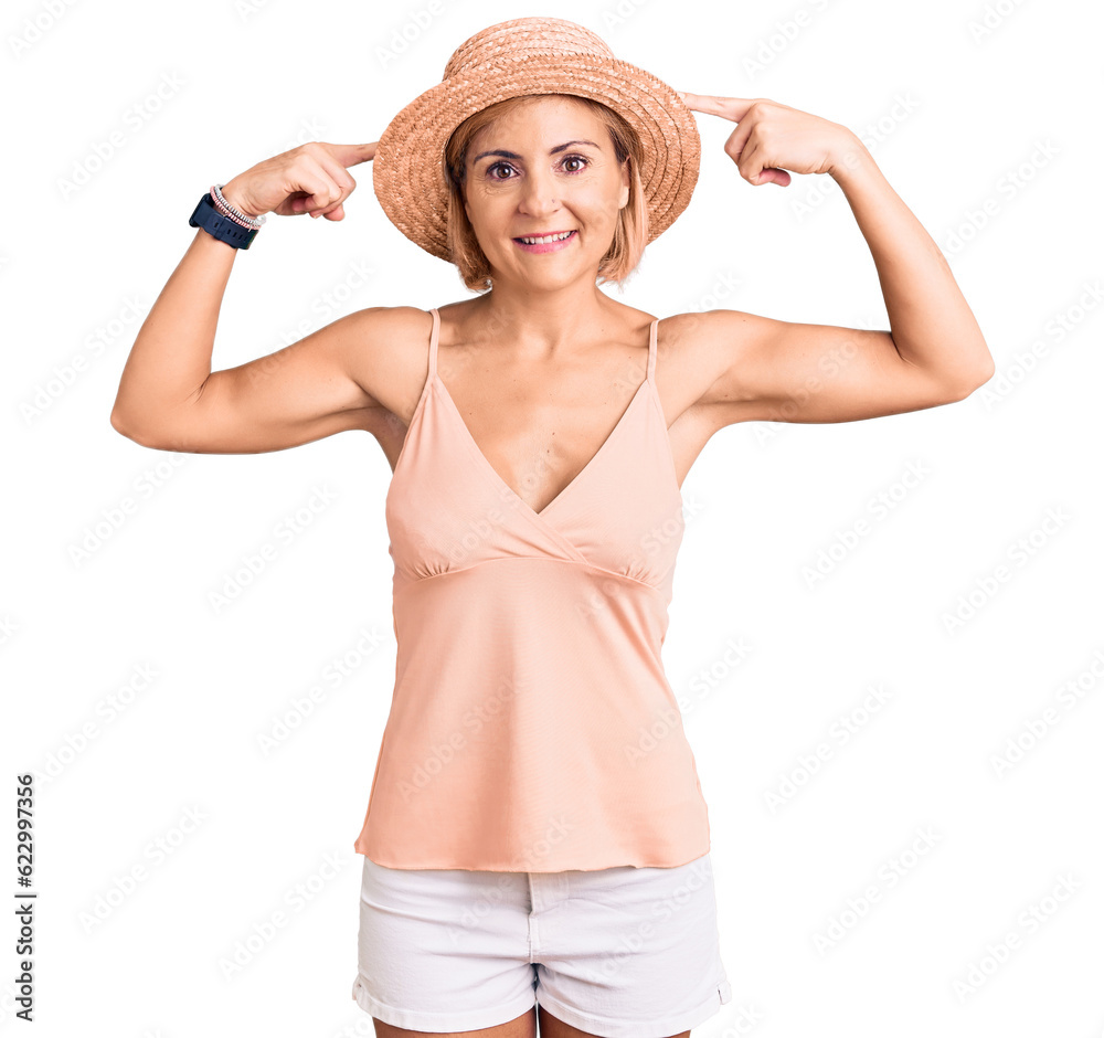 Sticker Young blonde woman wearing summer hat smiling pointing to head with both hands finger, great idea or thought, good memory