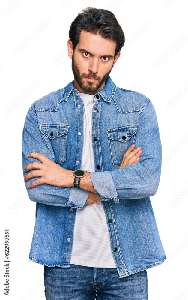 Poster Young hispanic man wearing casual clothes skeptic and nervous, disapproving expression on face with crossed arms. negative person.