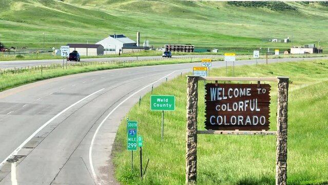 Welcome to Colorful Colorado state sign. Entering Weld country. Aerial establishing shot with long zoom lens.