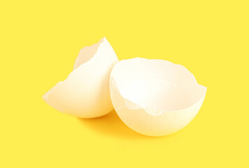 Broken white eggshell on yellow background