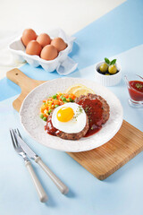 fried eggs with bacon and vegetables