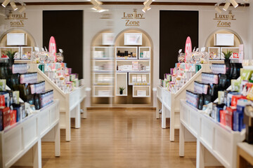 Modern interior of cosmetics store with products on the shelves in shopping mall