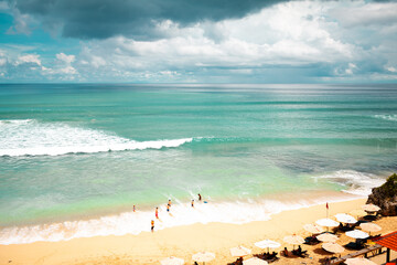 A lot of people on the beach swimming and relaxing om sunny warm day view from above hill high ground with copter