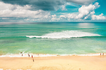 A lot of people on the beach swimming and relaxing om sunny warm day view from above hill high ground with copter