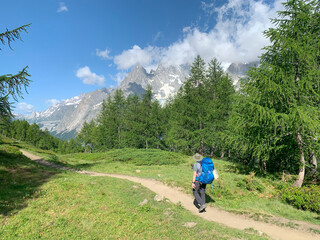 Hikers along the Tour du Mont Blanc. 170 km trekking trail through France, Italy and Switzerland, it is one of the world’s classic multi day treks. Val Ferret, Courmayeur, Italy.