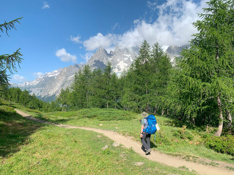 Hikers along the Tour du Mont Blanc. 170 km trekking trail through France, Italy and Switzerland, it is one of the world&rsquo;s classic multi day treks. Val Ferret, Courmayeur, Italy.