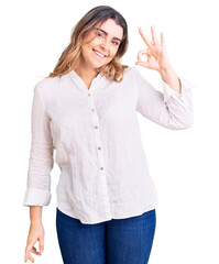 Young caucasian woman wearing casual clothes smiling positive doing ok sign with hand and fingers. successful expression.