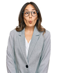 Young brunette woman wearing business clothes making fish face with lips, crazy and comical gesture. funny expression.