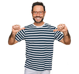 Middle age man wearing casual clothes and glasses looking confident with smile on face, pointing oneself with fingers proud and happy.