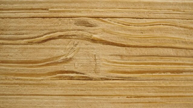 Wooden fibers on a board, knots. Macro slider, dolly.