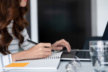 Young woman engaged in online study or project work.