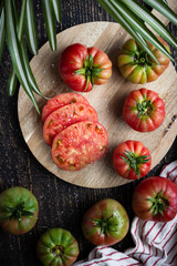 Fresh tomatoes on wooden board, top view..Summer salad or tomato sauce