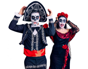 Young couple wearing mexican day of the dead costume over background crazy and scared with hands on head, afraid and surprised of shock with open mouth