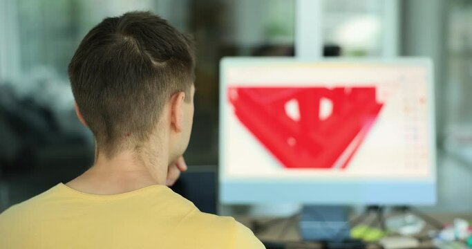 Engineer producing industrial products on PC software. Male designer uses computer screen to design technical components of machine and container