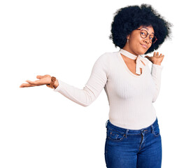 Young african american girl wearing casual clothes and glasses clueless and confused expression...