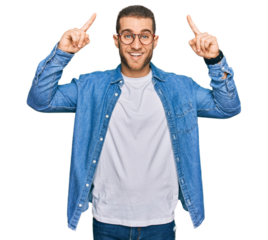 Young caucasian man wearing casual clothes smiling amazed and surprised and pointing up with fingers and raised arms.
