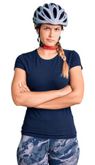 Beautiful caucasian woman wearing bike helmet skeptic and nervous, disapproving expression on face with crossed arms. negative person.