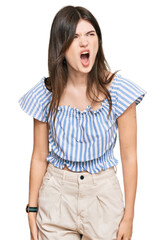 Young beautiful caucasian girl wearing casual clothes angry and mad screaming frustrated and furious, shouting with anger. rage and aggressive concept.