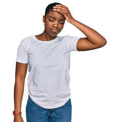 Young african american woman wearing casual white t shirt worried and stressed about a problem with hand on forehead, nervous and anxious for crisis